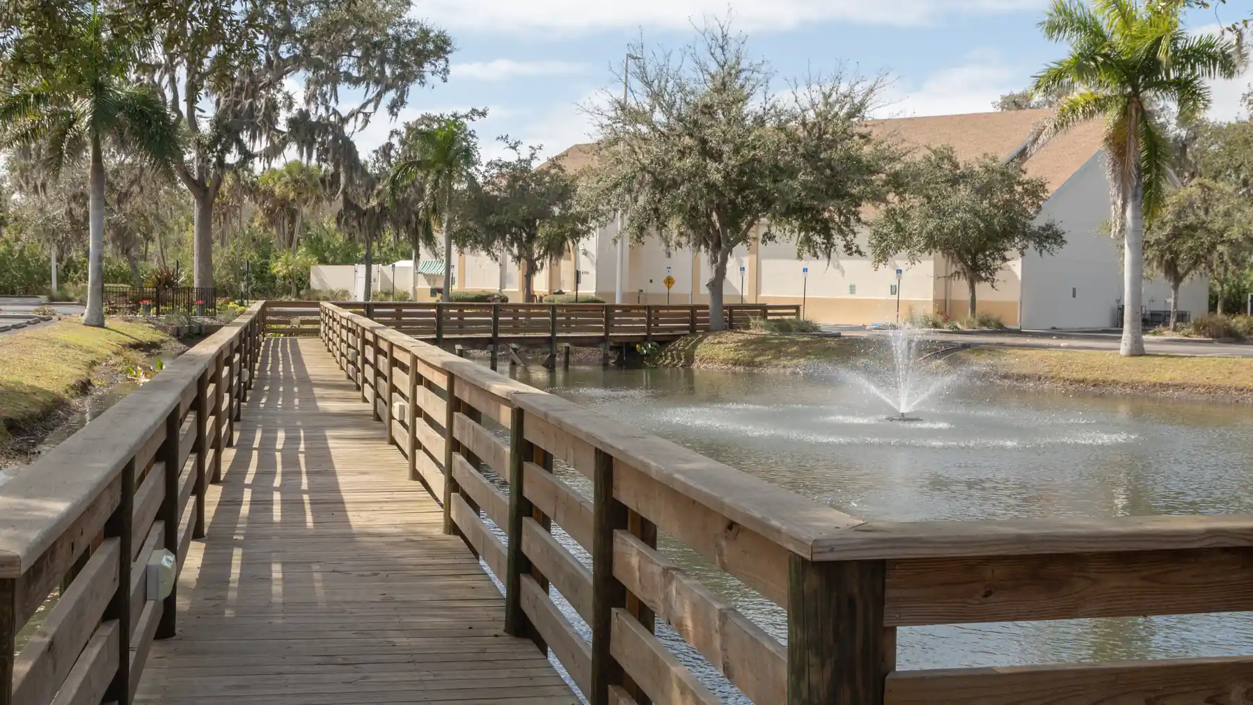 A boardwalk over a pond, shaded by oaks, at Rocky Bluff in Ellenton.