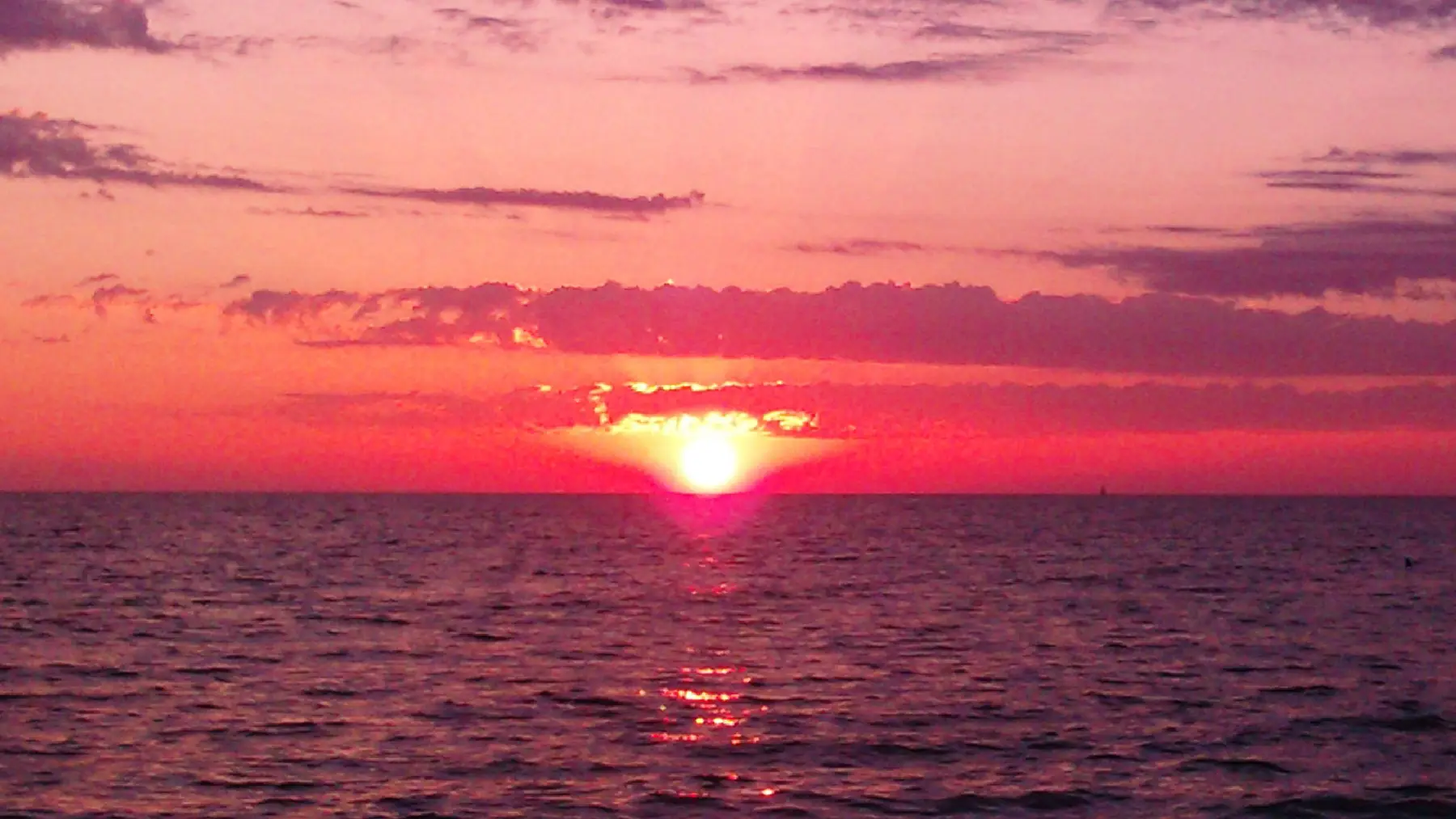 The sun going down over the Gulf of Mexico off Holmes Beach.