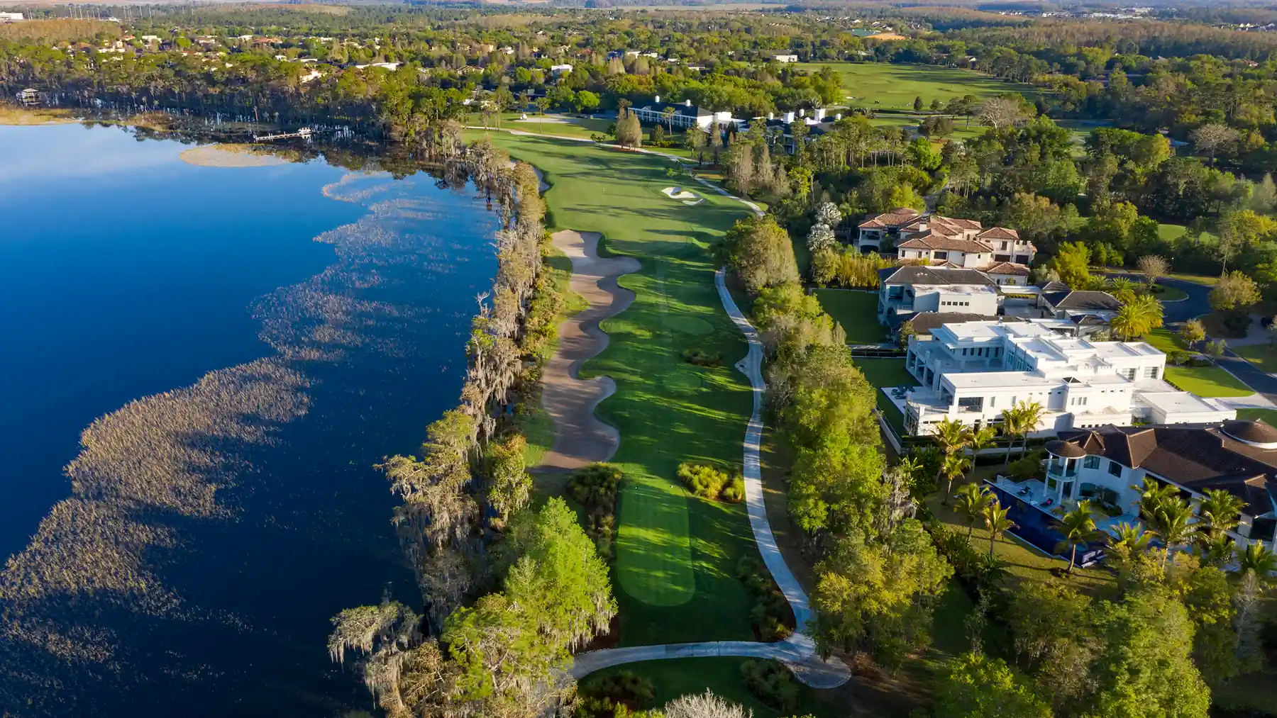 A Florida golf community laid out around a lake, seen from the air.