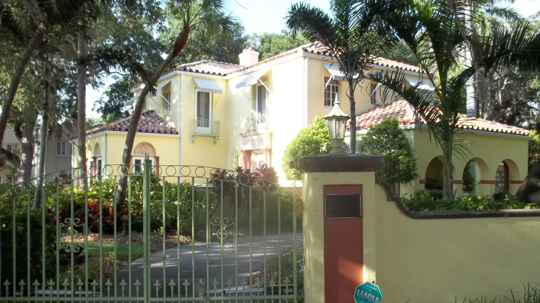 A 1920s Mediterranean revival house behind a gate in Whitfield Estates.